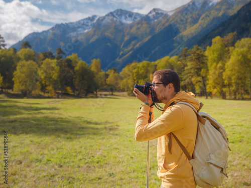 trip to Caucasus mountains, Arkhyz, Teberdinsky reserve. concept of discovery and exploration of wild places in early autumn. Man hiking in mountains with backpack and photo camera