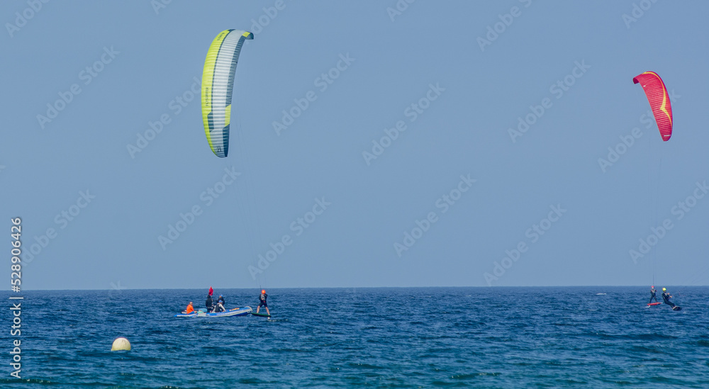 Kite-surfing. Many silhouettes of kites in the sky. Holidays on nature. Artistic picture. Beauty world. 