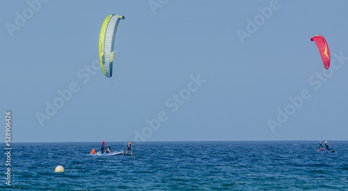 Kite-surfing. Many silhouettes of kites in the sky. Holidays on nature. Artistic picture. Beauty world. 
