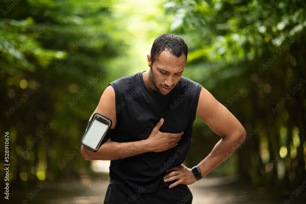 Muscular black man with heart pain, training outdoors Muscular black man with heart pain, training outdoors
