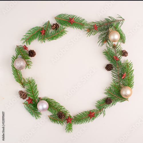 Christmas holiday background, frame with fir branches, baubles and cones, winter season greeting card with copy space 