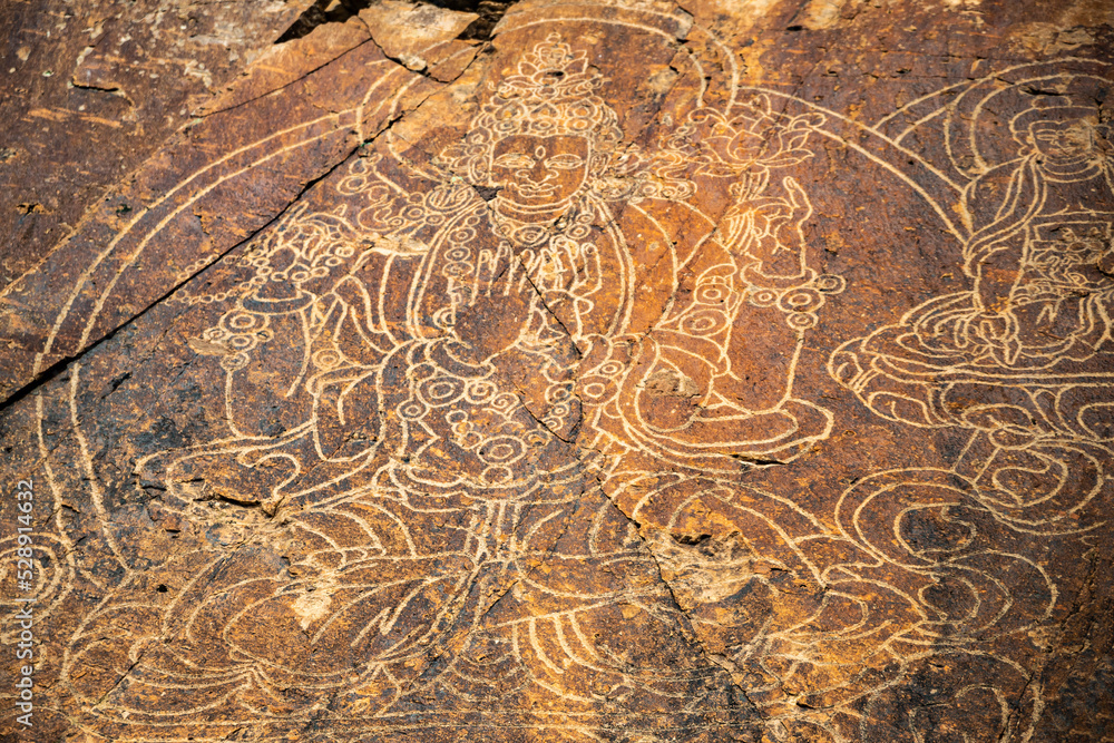 Fototapeta premium An ancient Buddha image on a stone rock. UNESCO World Heritage Site.