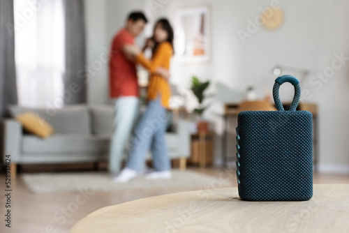 Selective focus on portable speaker over dancing couple