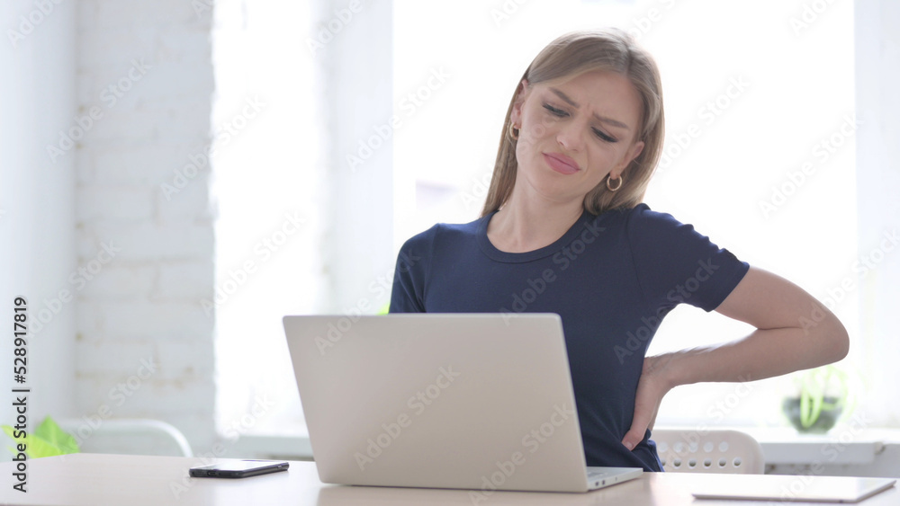 Woman having Back Pain while using Laptop Woman having Back Pain while using Laptop