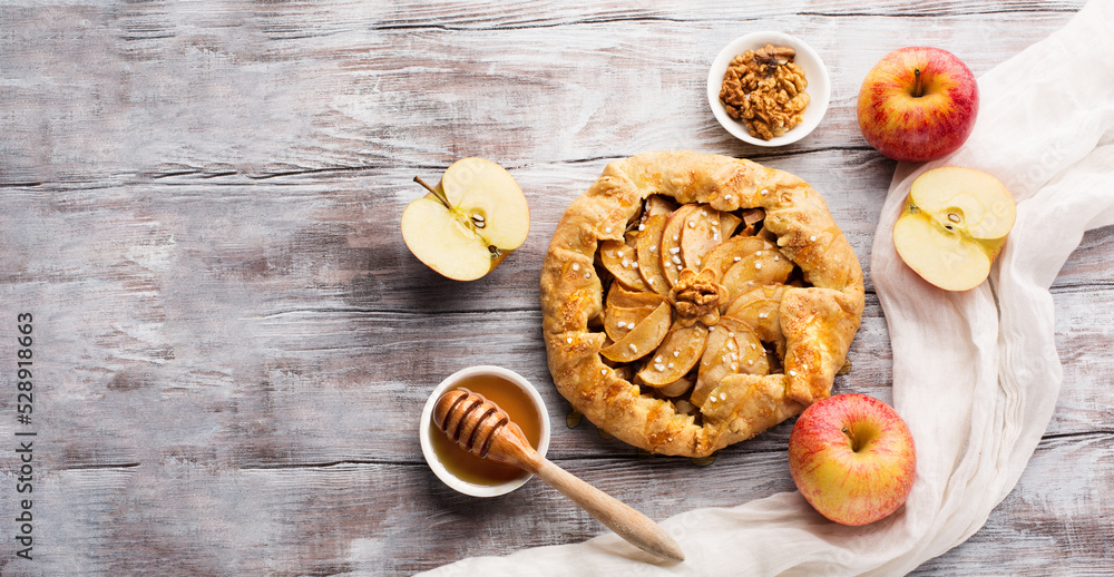 Autumn Homemade Apple Pie Galette with Apples and Honey on White Wooden Table.