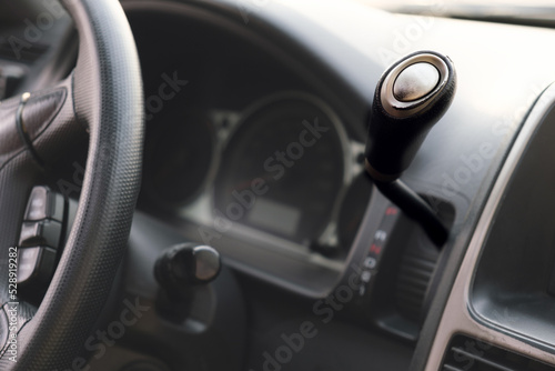 Shift lever of the automatic transmission on the wheel. Details in the interior of the car. Selective focus.