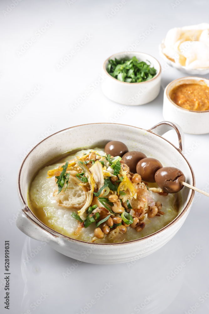 Bubur Ayam or Indonesian Rice Porridge with Shredded Chicken, cheese stick and cakwe. Bubur Ayam or Indonesian Rice Porridge with Shredded Chicken, cheese stick and cakwe.