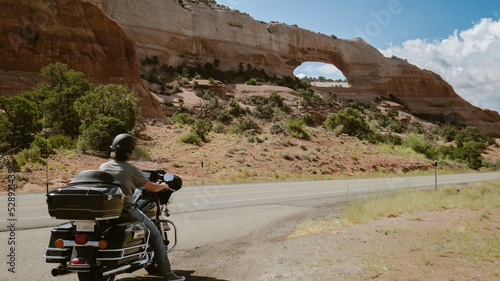 Hombre en moto de aventura por montañas rocosas. Man on adventure motorcycle through rocky mountains. photo