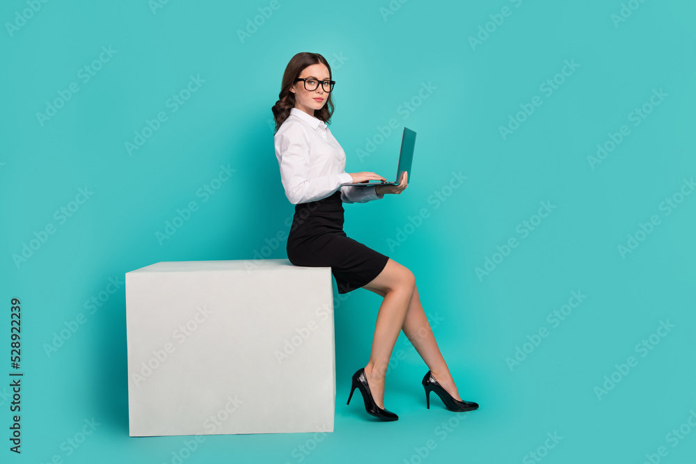 Profile side full length photo of successful lady ceo sit podium chat partners netbook isolated cyan color background Profile side full length photo of successful lady ceo sit podium chat partners netbook isolated cyan color background