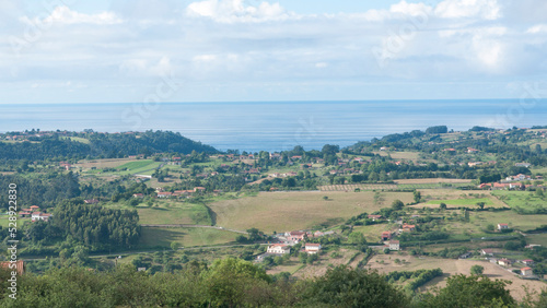 Granjas y casas rurales en valle verde junto al mar