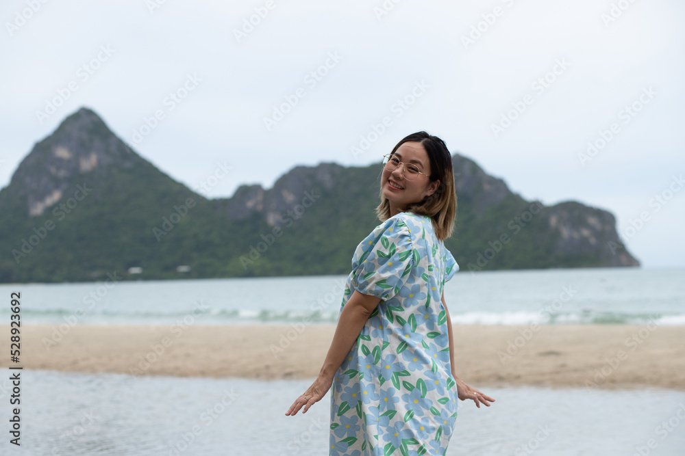 Beautiful young pregnant woman walking on the beach feel peace Beautiful young pregnant woman walking on the beach feel peace