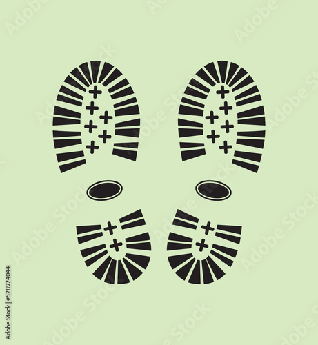 Black shoe print on green background