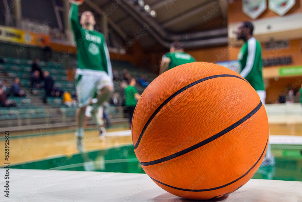 A basketball stands in front of the players A basketball stands in front of the players