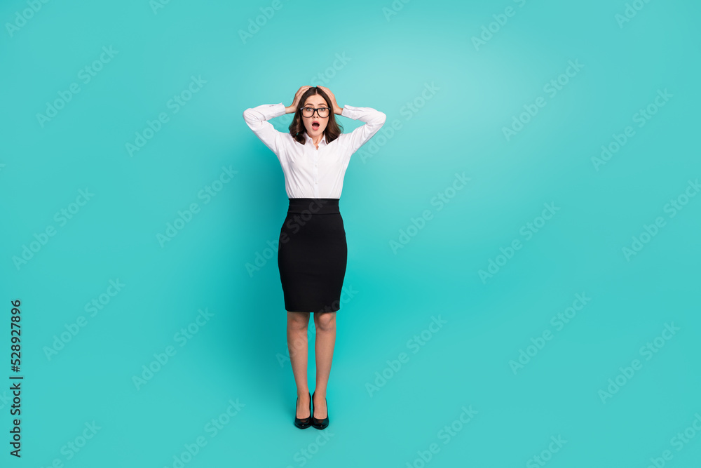 Full size photo of nervous economist lady made error in her project feeling shocked isolated on cyan color background Full size photo of nervous economist lady made error in her project feeling shocked isolated on cyan color background