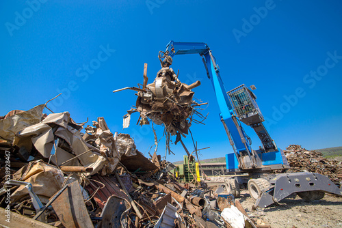 scrap metal grab on a bright sunny day