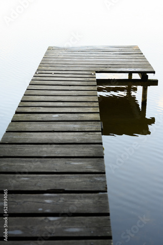 close up of wooden footbridge on lake, early morning walk, Germany