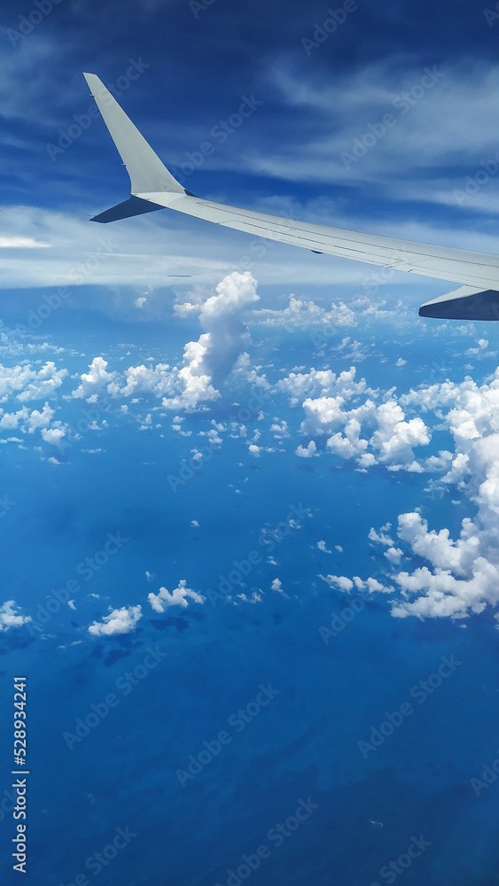 View from an Airplane during flight with clouds View from an Airplane during flight with clouds