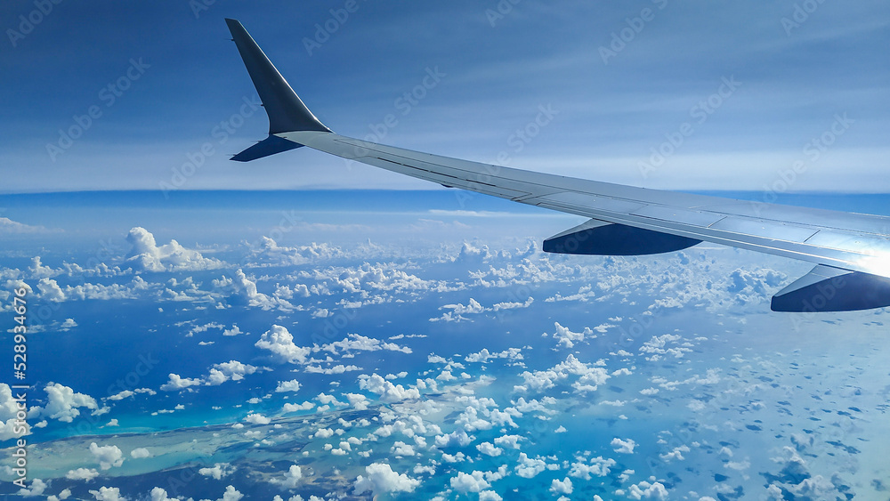 Fototapeta premium View from an Airplane during flight with clouds
