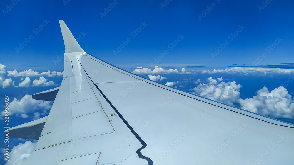 View from an Airplane during flight with clouds View from an Airplane during flight with clouds