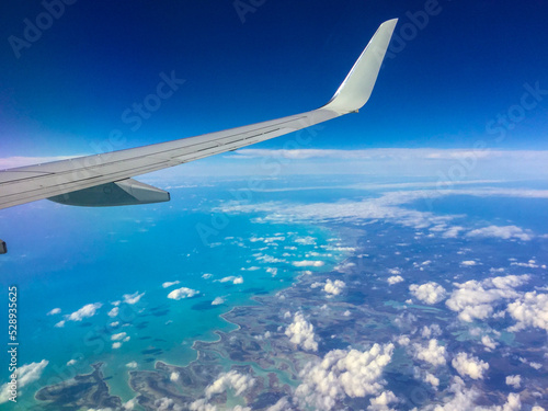 Plane flying over a Caribbean Island