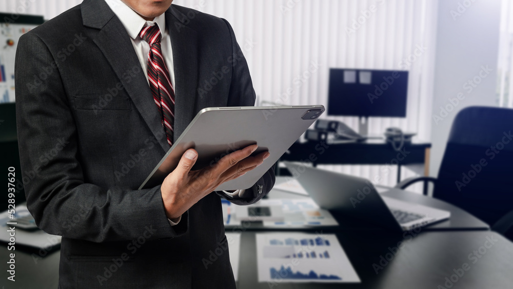 Close up image of business man holding a digital tablet online banking, internet network communication concept in office Close up image of business man holding a digital tablet online banking, internet network communication concept in office