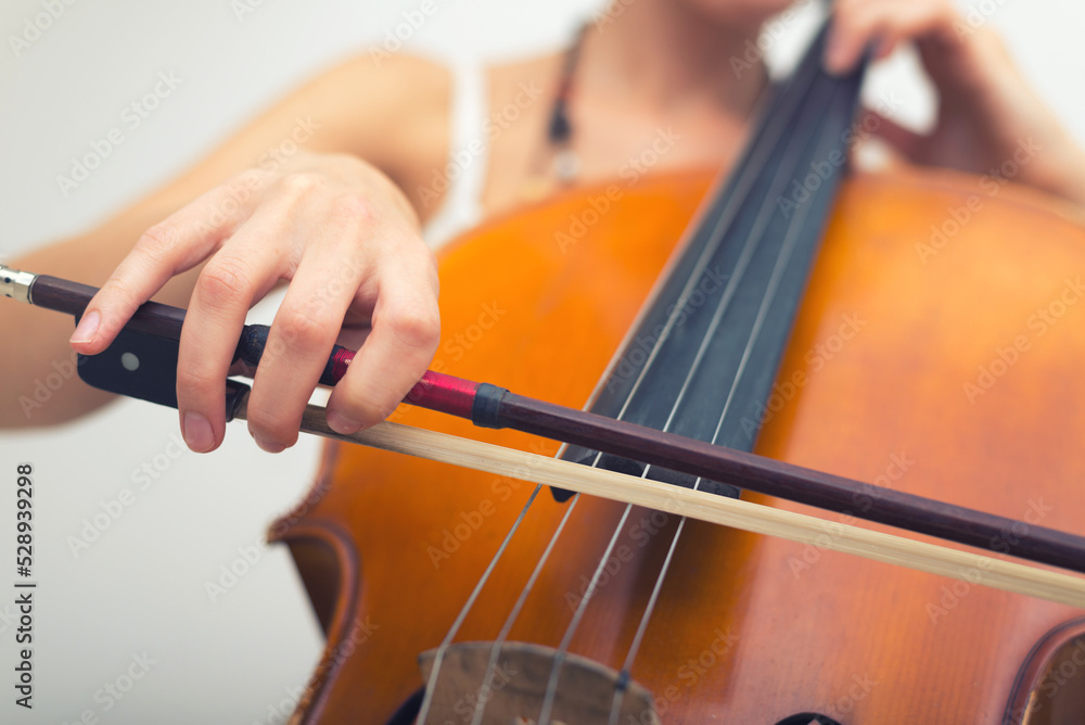 Young woman playing cello on the concert at night Young woman playing cello on the concert at night