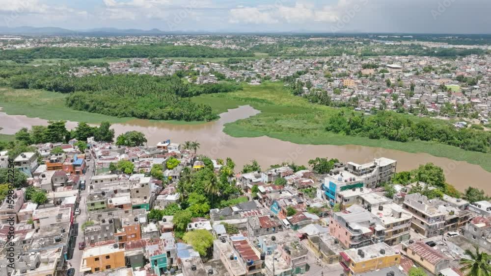 Aerial panning shot of neighborhood in Santo Domingo near Rio Ozama River during sunny day on Dominican Republic Aerial panning shot of neighborhood in Santo Domingo near Rio Ozama River during sunny day on Dominican Republic