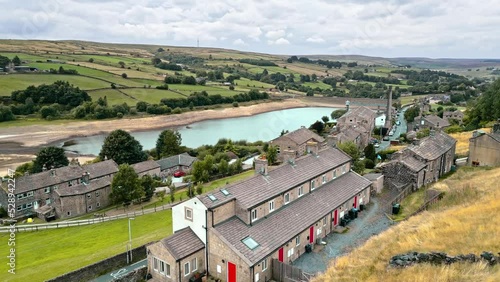 Aerial drone fottage of a typical rural Yorkshire stone built village. Shot at Leeming above Oxenhope and adjacent to Leeming Reservoir near Haworth in the heart of West Yorkshire's Bronte Country . photo