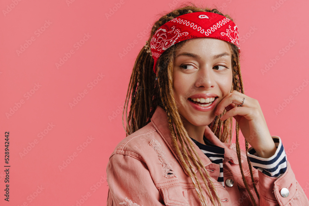 White woman with dreadlocks smiling while looking aside White woman with dreadlocks smiling while looking aside