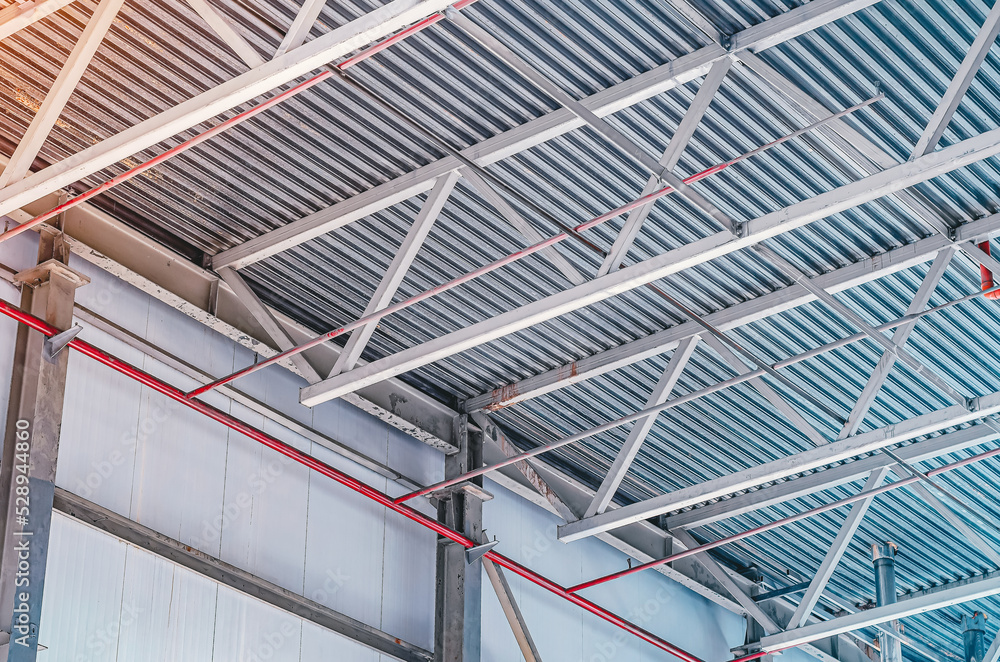 Metal trusses. The ceiling of an industrial workshop.