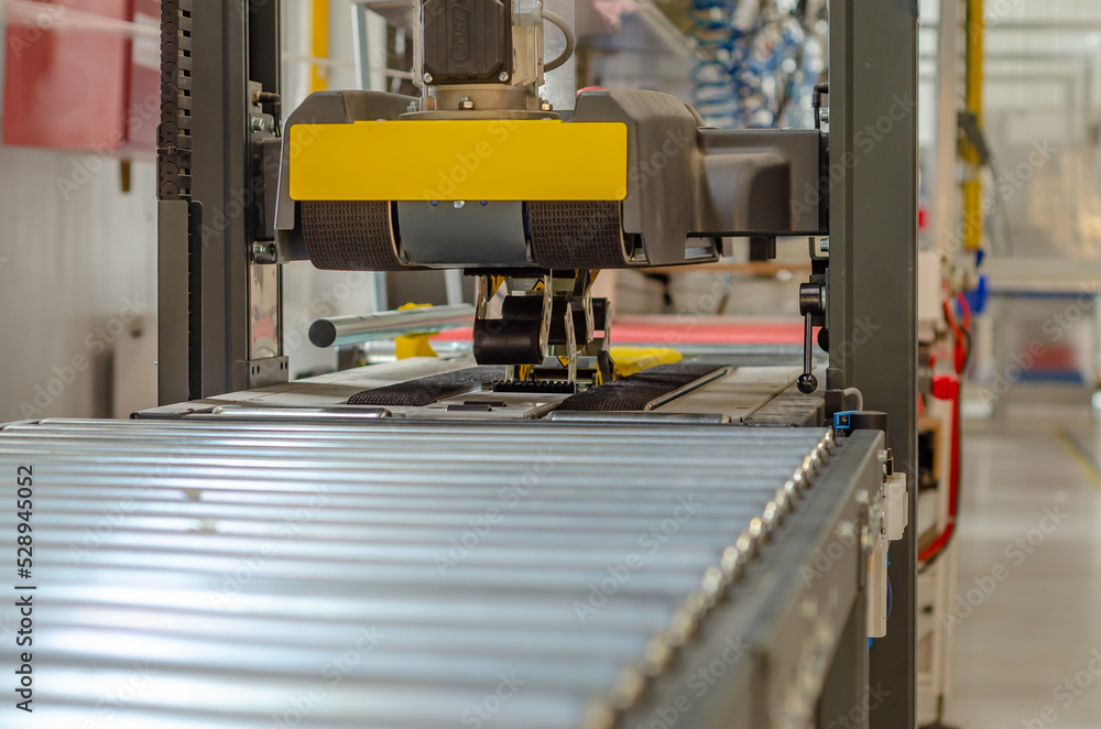 Front view cardboard packaging machine. Production line of packaging. Industry. Front view cardboard packaging machine. Production line of packaging. Industry.