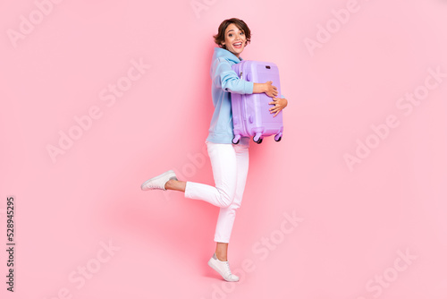 Photo of overjoyed lady buy new bag go excursion sightseeing explore new country wear stylish clothes isolated on pink color background