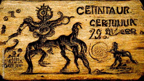 Astrological sign of sagittarius, engraving and drawing on a wooden board, antique wood, for astrologer and horoscope, centaur