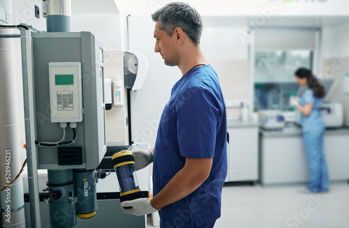 Laboratory assistant sends results of patient's lab tests to attending physician using pneumatic mail photo