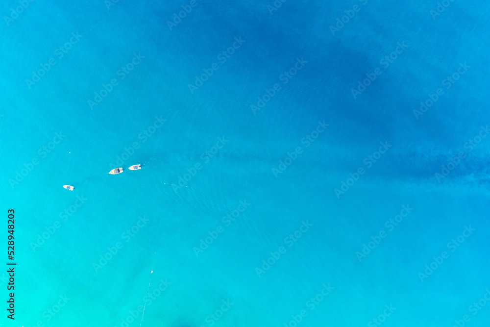 Drone aerial photo of sailing boats in open mediterranean turquoise azure sea. Top view