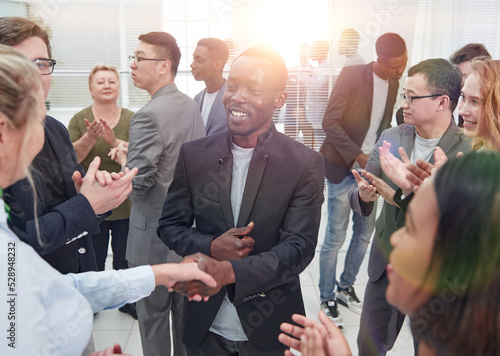 Portrait of creative business team standing together and laughin