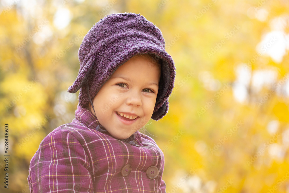 Portrait of caucasian five years old little girl looking at camera in autumn park with yellow light Portrait of caucasian five years old little girl looking at camera in autumn park with yellow light