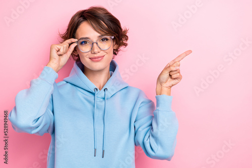 Closeup photo of young attractive gorgeous cute woman finger pointing empty space new eyeglasses confident businesswoman isolated on pink color background