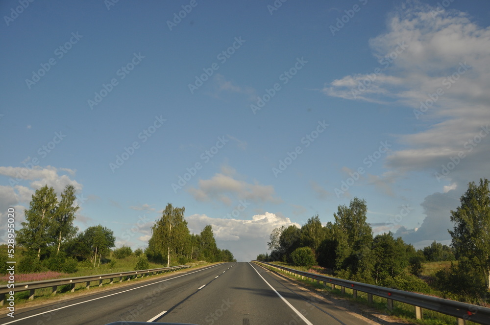 asphalt road, car trip view from the window around the field green grass beautiful sky asphalt road, car trip view from the window around the field green grass beautiful sky