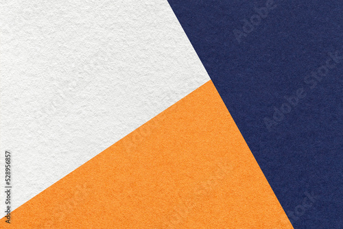 Valokuvatapetti Texture of craft navy blue, white and orange shade color paper background, macro