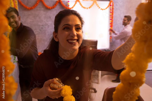 Employees decorating office on the occasion of Diwali