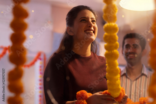 Female employee decorating office on the occasion of Diwali photo