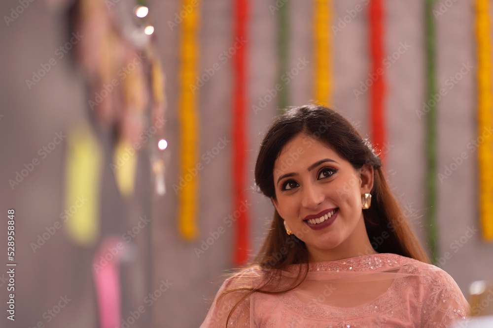 Portrait of young woman in traditional outfit in office during Diwali celebration Portrait of young woman in traditional outfit in office during Diwali celebration