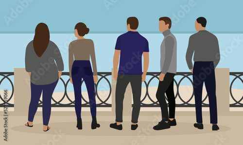 Five people stand on the embankment and look at the water