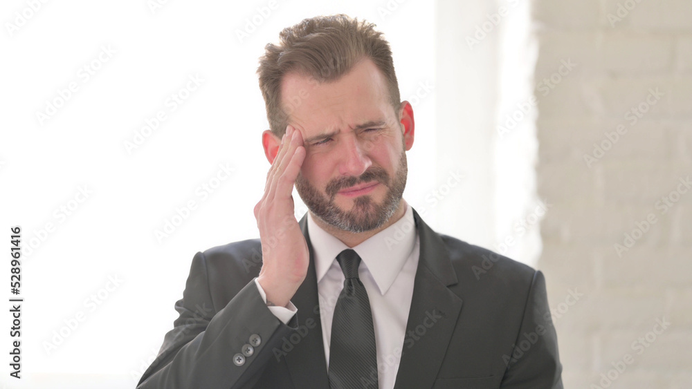 Tense Middle Aged Businessman having Headache Tense Middle Aged Businessman having Headache