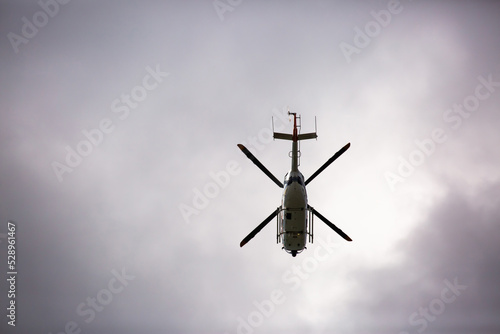 Helicopter close-up on the background of a stormy sky. Rescue helicopter flies in the sky with clouds.