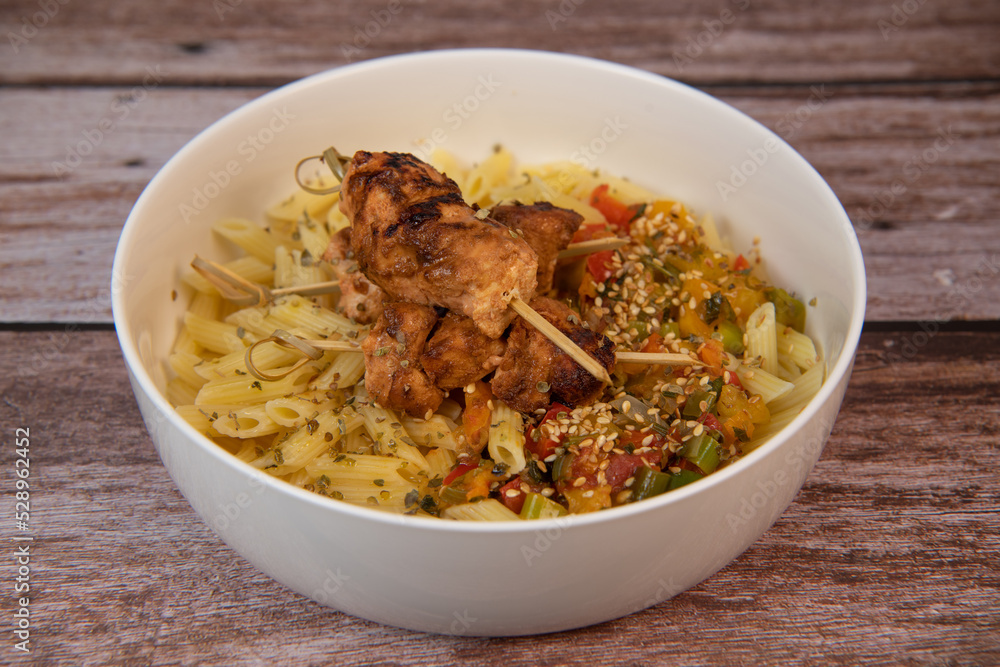 Recipe for chicken shish taouk brochettes with pasta and vegetables. High quality photo Recipe for chicken shish taouk brochettes with pasta and vegetables. High quality photo
