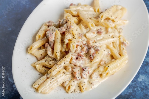 Wall Mural Top shot of the penne alfredo pasta on a white plate