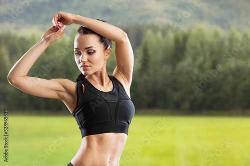 A sport woman warming up outdoors, Fitness woman doing stretch exercise stretching her arms