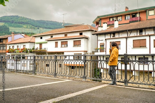 typical house of northern Spain. Woman look the old Basque houses in Orozko photo
